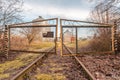 Closed iron gates and old railway rails for trains