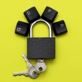 closed iron padlock with keys on a yellow background on the lock lever the keys of the computer keyboard are lined with Royalty Free Stock Photo