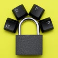 Closed iron padlock on a yellow background on the lock arm the keys of the computer keyboard are laid out with the abbreviation Royalty Free Stock Photo