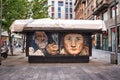 A closed kiosk on Via Torino shopping street with graffiti representing and old man and an old woman