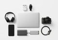 A closed laptop at the center, wireless earbuds in their case, a Royalty Free Stock Photo