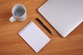 Closed Laptop Beside Empty Journal With Pen And Coffee Mug Over Table. Notebook Computer With Blank Notepad Ballpen