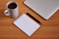 Closed Laptop Beside Empty Journal With Pen And Coffee Mug Over Table. Notebook Computer With Blank Notepad Ballpen