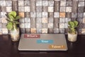 Closed laptop with succulent plant on wood table and what`s your talent ? concept Royalty Free Stock Photo