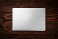 Closed laptop on wooden background