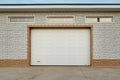 Closed light beige automatic garage doors for private house garage Royalty Free Stock Photo