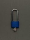 A closed lock with an inserted key on a dark gray background Royalty Free Stock Photo