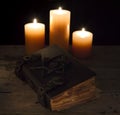 Closed magic book with candles Royalty Free Stock Photo