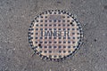 Closed manhole cover on a city street Royalty Free Stock Photo