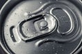 Closed metal can of cola on black background. Top view. Can drink with water drops. Steel shiny bottle of beer