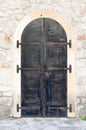 Closed metal door with stone wall on ancient fortress Royalty Free Stock Photo