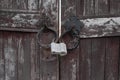 Closed metal lock door security protection padlock. old wooden door. Royalty Free Stock Photo