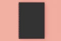 Closed notebook spiral bound on red background Royalty Free Stock Photo