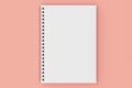 Closed notebook spiral bound on red background Royalty Free Stock Photo