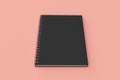 Closed notebook spiral bound on red background Royalty Free Stock Photo