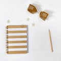 Closed notebook on spring with gold lined cover, hourglass and wooden pencil on white table Royalty Free Stock Photo