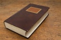 Closed Old Book on a Wooden Table Royalty Free Stock Photo