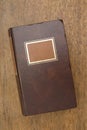 Closed Old Book on a Wooden Table Royalty Free Stock Photo
