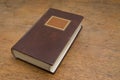 Closed Old Book on a Wooden Table Royalty Free Stock Photo