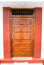 Closed ornate wood door of an upscale home, accented with an woo Royalty Free Stock Photo