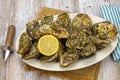 Closed oysters in a dish with lemon