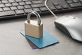 Closed padlock on credit cards and computer mouse and keyboard on the table. Cyber security and protection concept Royalty Free Stock Photo