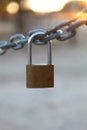 Closed padlock hanging from a chain Royalty Free Stock Photo