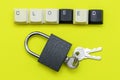 A closed padlock with keys on a yellow background at the top the inscription closed is laid out from the keys of a computer Royalty Free Stock Photo