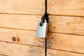 Closed padlock on a painted brown pine wooden door Royalty Free Stock Photo