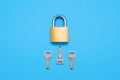 Closed padlock with three different keys on a blue background Royalty Free Stock Photo