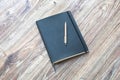 Closed planner with pen is on a wooden desk. Royalty Free Stock Photo