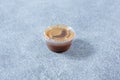 closed plastic condiment cup, balsamic vinaigrette dressing, brown, lid