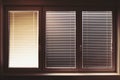 Closed plastic window on sunny day with horizontal plastic blinds