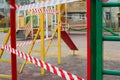 Closed playground is blocked by red warning tape. Quarantine Covid-19 Royalty Free Stock Photo