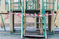 Closed playground during quarantine 2020. White and red warning tape pulled around. Covid-19 Coronavirus Pandemic.Selective focus Royalty Free Stock Photo