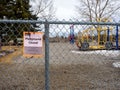 Closed Playground sign on a fence due to Covid 19 pandemic