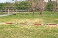 Closed public places during quarantine and pandemic, red and white tape restricts the passage