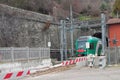 Closed railway crossing and train in tunnel. Riola, Bologna, Emilia-Romagna, Italy