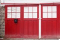 Closed red doors with creeping vines Royalty Free Stock Photo