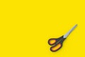 Closed scissors on yellow background. Top view Royalty Free Stock Photo