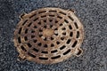 Closed sewer manhole, which is located on the sidewalk