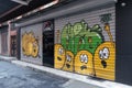 Closed shop exterior with metal rolling doors painted with colorful graffiti at Hoca Tahsin Street, Karakoy, Istanbul, Turkey