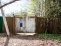 closed shubby old wooden gate in wooden fence Royalty Free Stock Photo