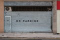 Closed shutter on store or shop front saying no parking Royalty Free Stock Photo