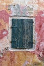 Closed shutters on a window of an old building in Paxoi island, Greece