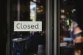 Closed sign hanging outside a restaurant, store, office or other