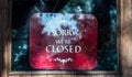 Closed sign over red background in shop window Royalty Free Stock Photo