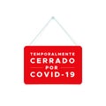 Closed sign with the text: Temporarily closed due to Covid-19 in Spanish. Temporalmente cerrado por Covid-19. Coronavirus crisis.