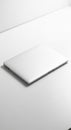 A closed silver laptop with a smooth metallic finish is positioned on a white surface. Royalty Free Stock Photo