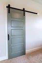 Closed sliding gray panel door with black handle against white wall of home Royalty Free Stock Photo